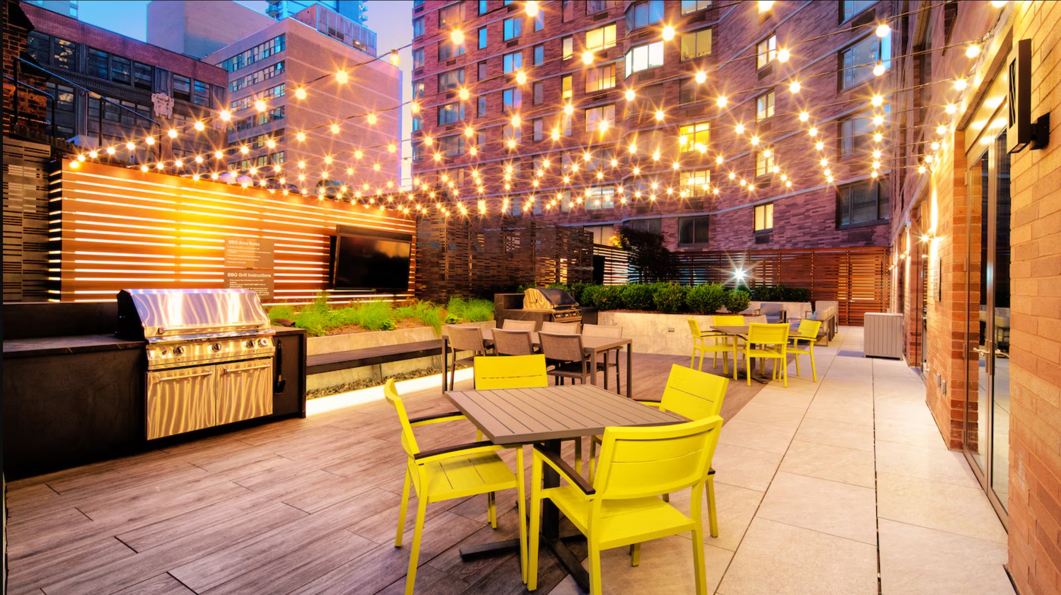 Avalon's shared terrace lit with string lights in the evening